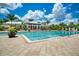 A lavish community pool offers cool, clear waters, surrounded by ample lounge chairs and tropical landscaping at 5608 Tidewater Preserve Blvd, Bradenton, FL 34208