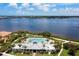 Aerial shot overlooking the community pool and clubhouse with water views for a serene retreat at 5608 Tidewater Preserve Blvd, Bradenton, FL 34208