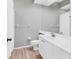 Well-lit bathroom with a white vanity, toilet, sink, and a large mirror at 5655 Downham Mdws, Sarasota, FL 34235