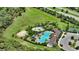 Aerial view of community amenities including a pool, splash pad, sports court, and lounging areas at 5715 Woodland Sage Dr, Sarasota, FL 34238