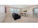 Spacious living room with bright light, modern furniture, and neutral tones at 5715 Woodland Sage Dr, Sarasota, FL 34238