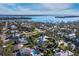 Aerial view of property surrounded by lush trees, close to beaches and a scenic bay at 581 Broadway St, Longboat Key, FL 34228