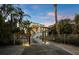 Charming two-story home with inviting entrance and tropical landscaping at dusk at 581 Broadway St, Longboat Key, FL 34228