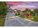 Wide driveway and well-manicured lawn with landscaped flowerbeds leading up to a charming single-story home at 6105 55Th Avenue E Cir, Bradenton, FL 34203