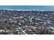 Aerial view of neighborhood near a large beach with clear blue water and white sandy beach at 614 Tropical Cir, Sarasota, FL 34242