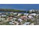 Aerial view of a waterfront home in a lush community near a bay at 614 Tropical Cir, Sarasota, FL 34242