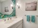 Stylish bathroom with a decorative mirror and modern lighting fixtures at 614 Tropical Cir, Sarasota, FL 34242