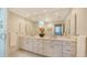 Elegant bathroom with a double sink vanity, marble countertops, and a large mirror at 614 Tropical Cir, Sarasota, FL 34242