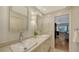 Elegant bathroom featuring double sinks, a marble countertop, and modern fixtures at 614 Tropical Cir, Sarasota, FL 34242