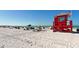 Beach with blue sky and a red lifeguard tower on Siesta Beach at 614 Tropical Cir, Sarasota, FL 34242