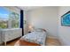 Bright bedroom with a large window, dresser, nightstand, and nautical themed decor at 614 Tropical Cir, Sarasota, FL 34242
