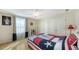 Bright bedroom with a window, ceiling fan, and two closets providing ample storage space at 614 Tropical Cir, Sarasota, FL 34242