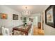 Bright dining room with a glass-top table and chandelier, perfect for entertaining at 614 Tropical Cir, Sarasota, FL 34242