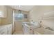 Bright laundry room featuring modern appliances, storage cabinets, and a utility sink at 614 Tropical Cir, Sarasota, FL 34242