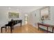 Living area with hardwood floors, a black piano, and elegant decor at 614 Tropical Cir, Sarasota, FL 34242
