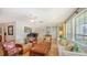 Comfortable living room with a piano, elegant furnishings, and lots of natural light at 614 Tropical Cir, Sarasota, FL 34242