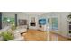 Open living room with hardwood floors, fireplace, and french doors to outdoor pool at 614 Tropical Cir, Sarasota, FL 34242