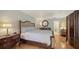 Cozy main bedroom features hardwood floors, a ceiling fan, and a calm, relaxing atmosphere at 614 Tropical Cir, Sarasota, FL 34242