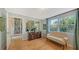 Bright office featuring hardwood floors, a comfortable couch, and seamless access to the library at 614 Tropical Cir, Sarasota, FL 34242