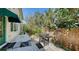 Outdoor grill on paved area with privacy fence and lush greenery next to the house at 614 Tropical Cir, Sarasota, FL 34242