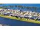 An aerial view of a neighborhood showcasing houses with screened-in pools and waterfront views at 6378 Grandview Hill Ct, Bradenton, FL 34203