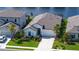 Aerial view of a meticulously landscaped home with lush gardens, a sprawling lawn, and serene water views at 6378 Grandview Hill Ct, Bradenton, FL 34203