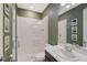 Modern bathroom with a glass enclosed shower, white tiled walls, a stylish vanity and tasteful decor at 6378 Grandview Hill Ct, Bradenton, FL 34203