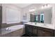 Spa-like bathroom with a soaking tub, double vanity, and modern lighting at 6378 Grandview Hill Ct, Bradenton, FL 34203