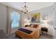 Cozy bedroom with stylish decor, a decorative chandelier, and plenty of natural light at 6378 Grandview Hill Ct, Bradenton, FL 34203