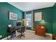 Cozy room featuring lush green walls, a window with natural light, and vintage lamps on a wooden dresser at 6378 Grandview Hill Ct, Bradenton, FL 34203