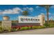 A welcoming community sign, 'Grandview at the Heights', with beautiful landscaping and blue skies at 6378 Grandview Hill Ct, Bradenton, FL 34203