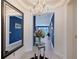 Elegant entryway featuring a mirrored accent wall, a stylish chandelier, and an open view into the living spaces at 6378 Grandview Hill Ct, Bradenton, FL 34203