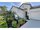Charming home featuring a well-manicured lawn, lush landscaping, a two-car garage and a welcoming front entrance at 6378 Grandview Hill Ct, Bradenton, FL 34203