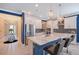 This kitchen features white cabinets, stainless steel appliances, a large island and lovely hanging lights at 6378 Grandview Hill Ct, Bradenton, FL 34203