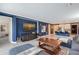 Spacious living room with a large flat screen TV and ample seating connected to a modern kitchen at 6378 Grandview Hill Ct, Bradenton, FL 34203