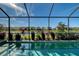 Enjoy this tranquil pool with views of a serene lake and lush landscaping at 6378 Grandview Hill Ct, Bradenton, FL 34203