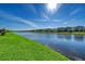 Panoramic lake view surrounded by well-manicured green spaces and beautiful neighborhood homes at 6378 Grandview Hill Ct, Bradenton, FL 34203
