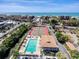 Breathtaking aerial view of a community pool, tennis courts, and Siesta Key beach in the background at 6415 Midnight Pass Rd # 904, Sarasota, FL 34242