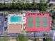Birds-eye view of community pool, tennis courts, landscaping, and parking area at 6415 Midnight Pass Rd # 904, Sarasota, FL 34242