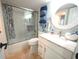 Bright bathroom with a marble vanity, new shower, and neatly arranged blue towels at 6415 Midnight Pass Rd # 904, Sarasota, FL 34242