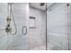 Modern glass shower featuring elegant tile work, a shower niche, and upscale fixtures at 6415 Midnight Pass Rd # 904, Sarasota, FL 34242