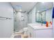 Bathroom featuring a glass shower with stone accents, a vanity and a commode at 6415 Midnight Pass Rd # 904, Sarasota, FL 34242