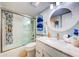 Contemporary bathroom showcasing a vanity with marble countertop, framed mirror, and tiled shower/tub at 6415 Midnight Pass Rd # 904, Sarasota, FL 34242