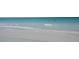 Picturesque beach featuring soft sand and clear, shallow waters perfect for enjoying sunny days at 6415 Midnight Pass Rd # 904, Sarasota, FL 34242
