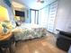 Cozy bedroom features a comfortable bed, tile floors, built in storage and sliding doors to a balcony at 6415 Midnight Pass Rd # 904, Sarasota, FL 34242