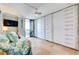 Bright bedroom with a private balcony, custom closets, and stylish neutral decor at 6415 Midnight Pass Rd # 904, Sarasota, FL 34242