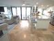 An open floor plan with a bright kitchen island, an eating area, and a comfortable living room at 6415 Midnight Pass Rd # 904, Sarasota, FL 34242
