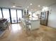 Bright kitchen featuring granite countertops, travertine floors, stainless steel appliances and a large island with bar stool seating at 6415 Midnight Pass Rd # 904, Sarasota, FL 34242