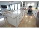 Bright kitchen with a central island and access to the living area with travertine flooring at 6415 Midnight Pass Rd # 904, Sarasota, FL 34242