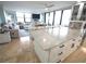 Open concept kitchen features island with marble countertop and seating, perfect for entertaining with a seamless view of the living room at 6415 Midnight Pass Rd # 904, Sarasota, FL 34242